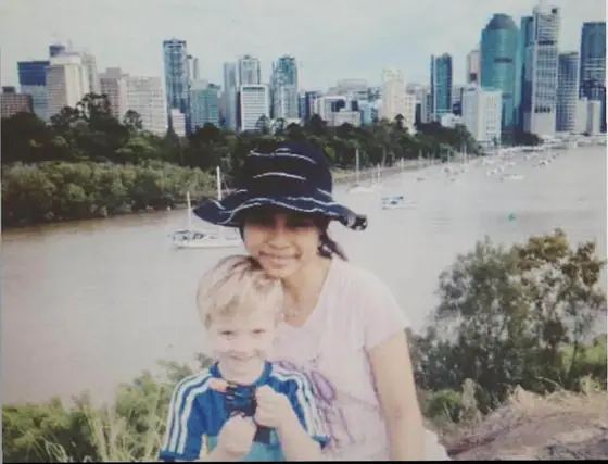 A nanny with a little boy outdoors
