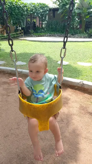 A baby on a garden swing