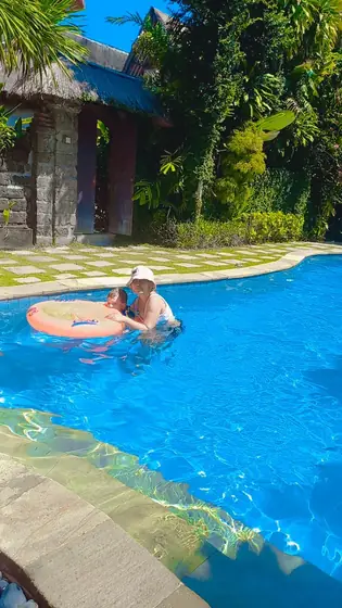 A child floating in a villa swimming pool