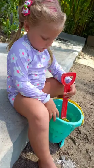 A little girl playing with a bucket and spade