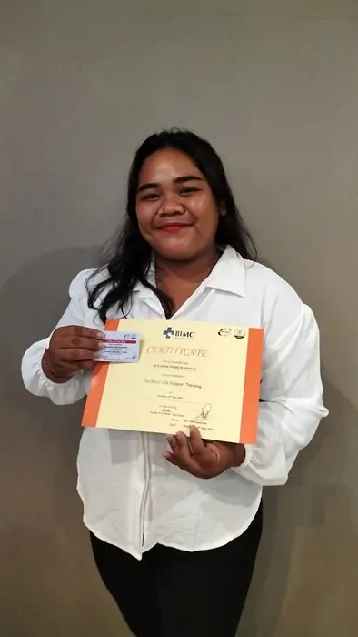 A Bella Bali Nanny team member holding a certificate