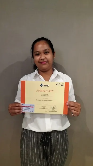A Bella Bali Nanny team member holding a certificate